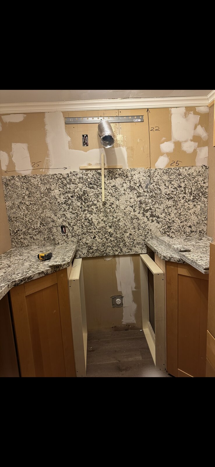 Granite countertop and backsplash fitted during a kitchen cabinetry install