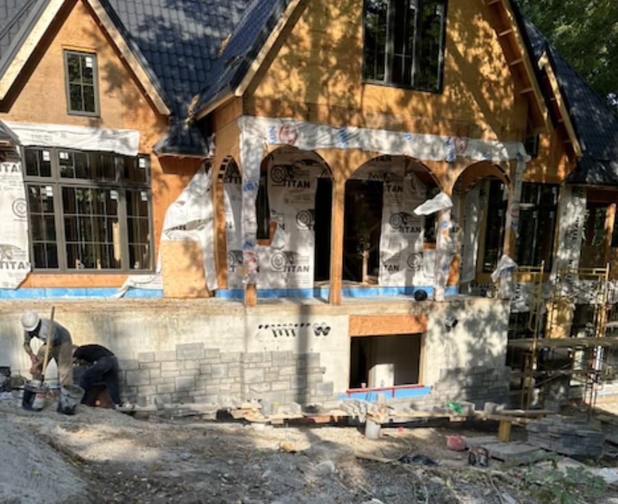 Stone archway and porch construction on a custom home