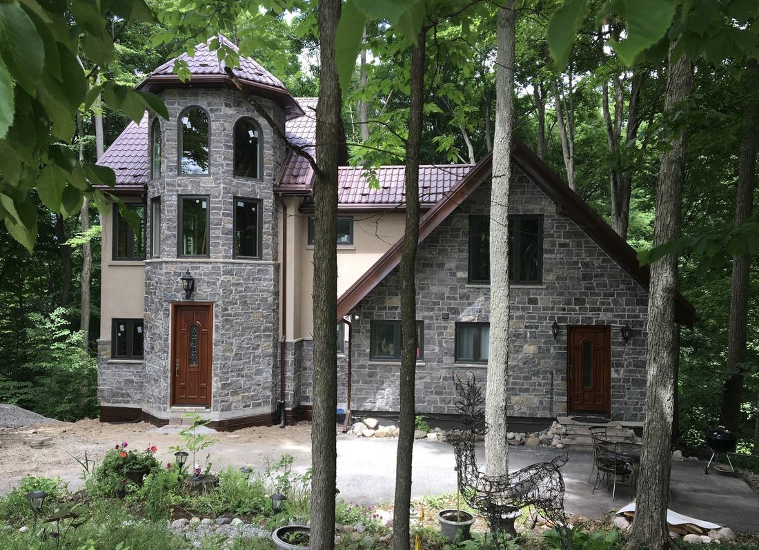 Completed Cavacor custom home with natural stone facade